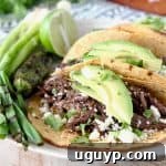Slow Cooker Shredded Beef Barbacoa Tacos with Avocado, Cotija Cheese and Cilantro