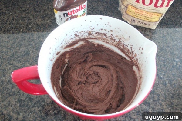Spreading Gluten Free Nutella Brownie Batter in Baking Dish