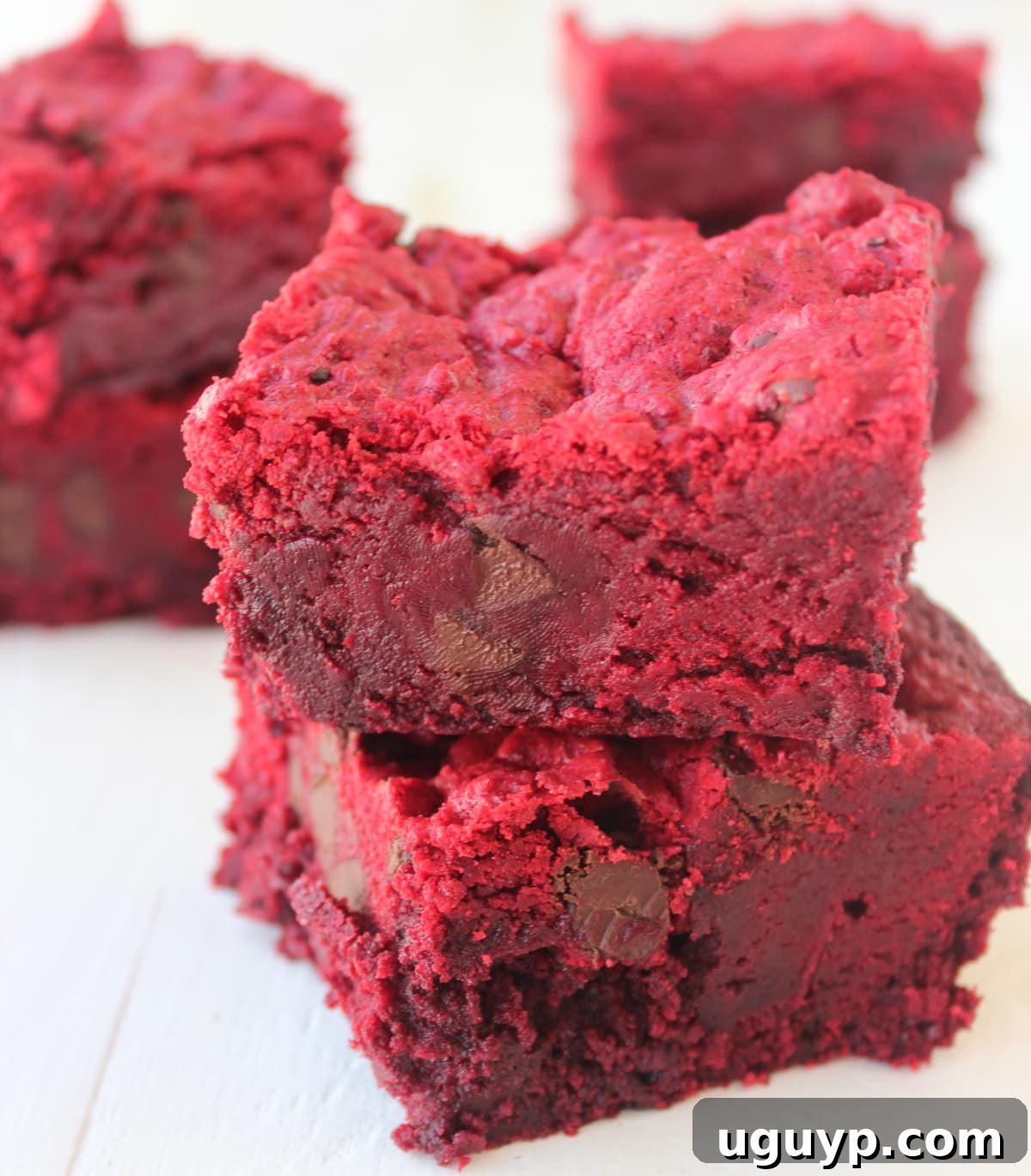 Two Red Velvet Brookies stacked on top of each other, showcasing their vibrant red layers and chocolate chips.