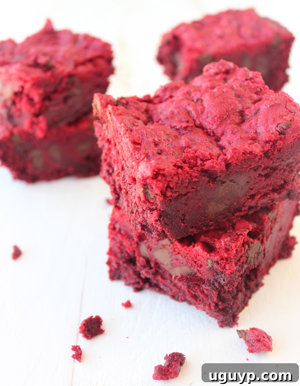 Two Red Velvet Brookies stacked on a clean white surface, highlighting their rich red color.