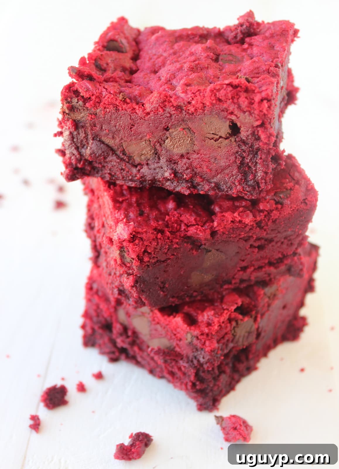 Three Red Velvet Brookies stacked on top of each other, displaying their distinct red velvet brownie and cookie layers.