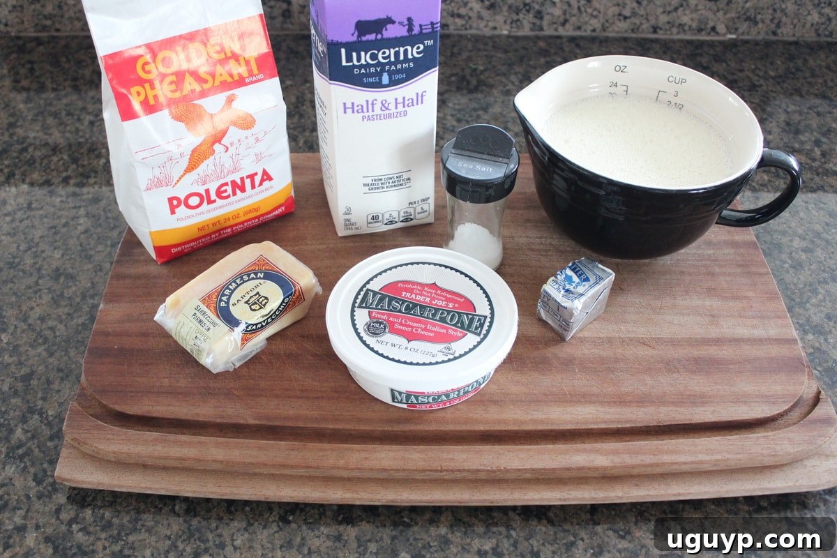 Ingredients for creamy cheesy polenta laid out on a wooden board