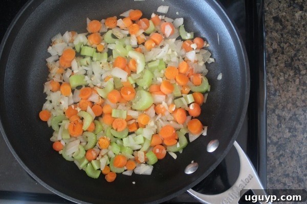 diced carrots, onions and celery in skillet on stove