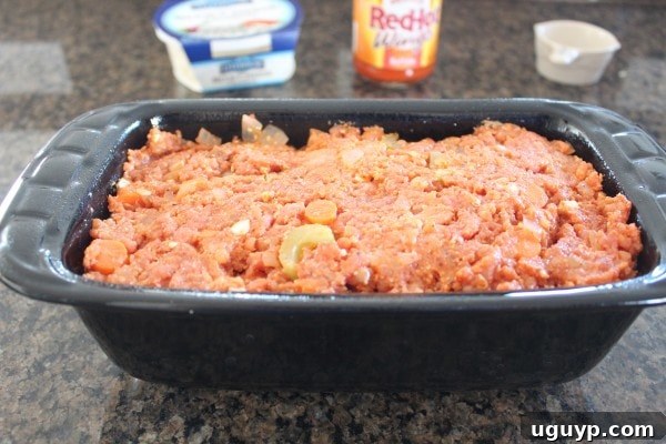 uncooked buffalo chicken meatloaf in loaf pan