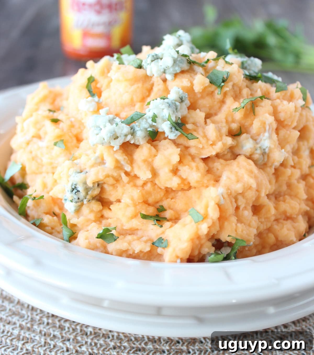 Buffalo Blue Cheese Mashed Potatoes Recipe - A serving of mashed potatoes next to a main course, showcasing its role as a perfect side.