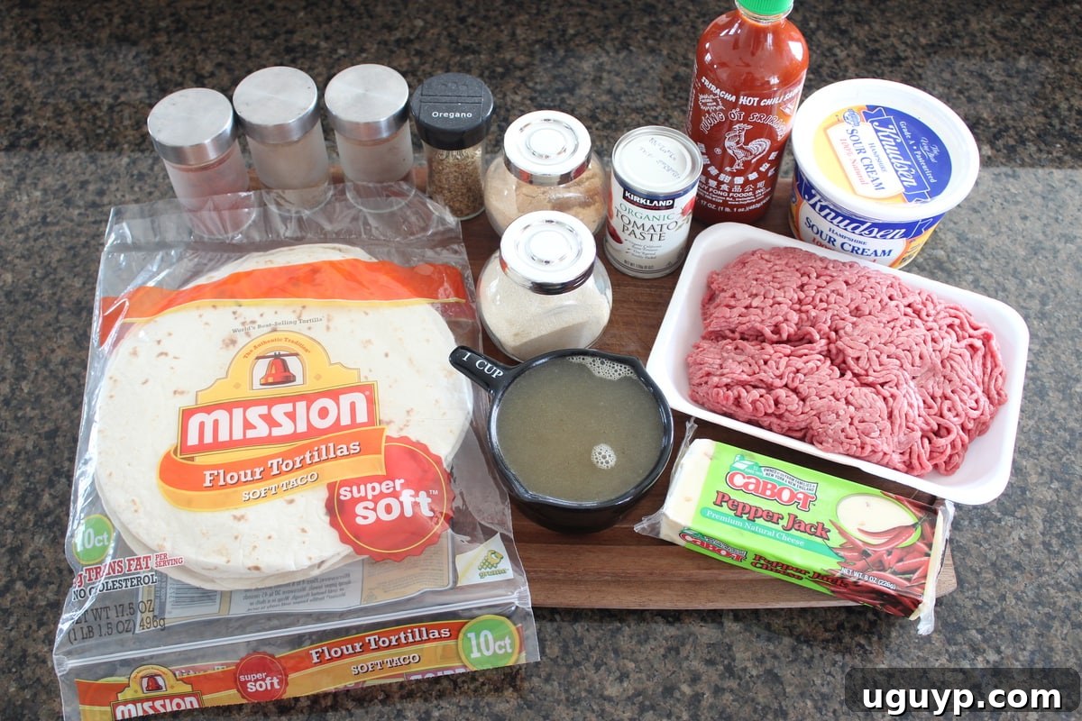 Creamy Sriracha Beef Enchilada Recipe Ingredients on a wood board