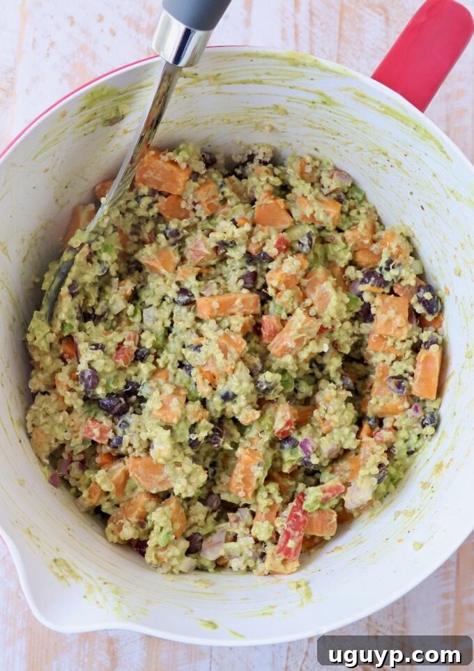 Mexican sweet potato salad fully mixed with the creamy avocado dressing in a large bowl