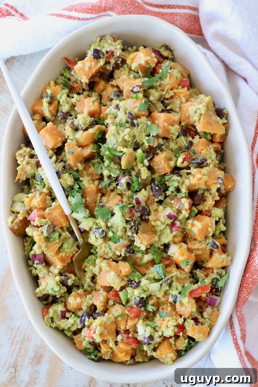 Mexican sweet potato salad served in a large rustic serving bowl with a spoon