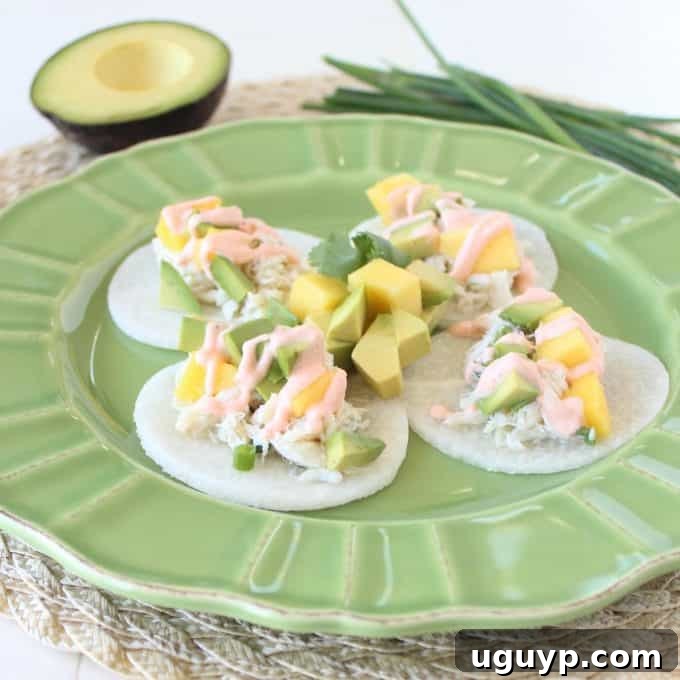 Close-up of Jicama Crab Tacos generously topped with fresh mango and creamy avocado