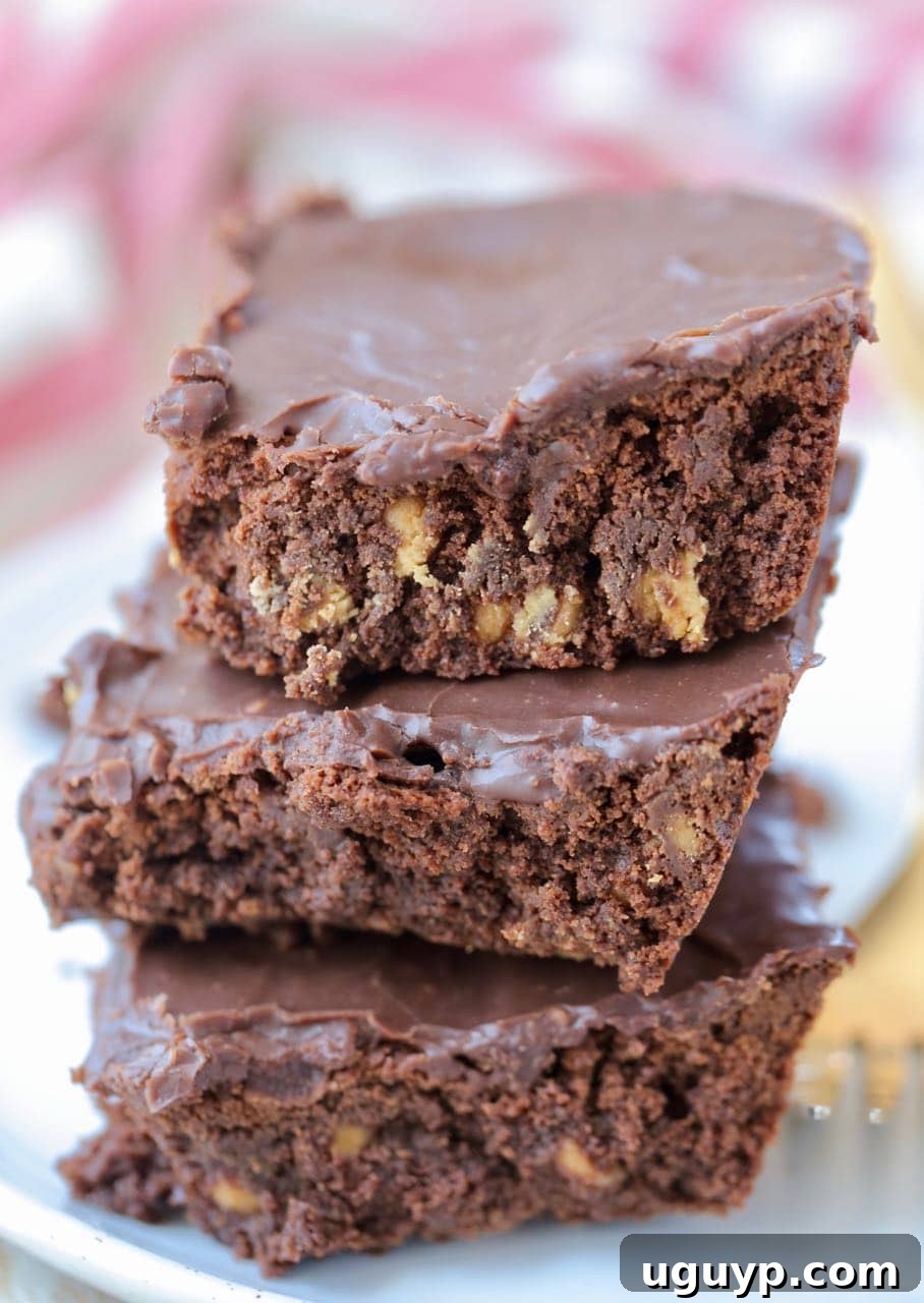 Stack of three double chocolate brownies on plate