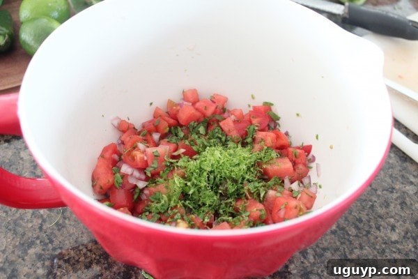 Mixing all ingredients for the Watermelon Serrano Salsa in a large bowl.
