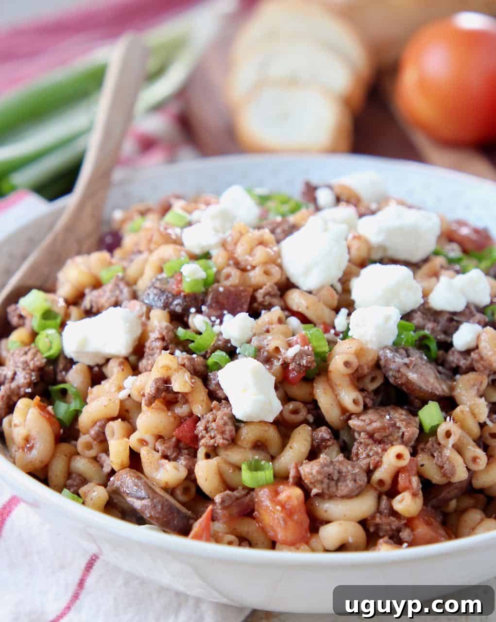 Ground lamb pasta in bowl topped with crumbled feta cheese