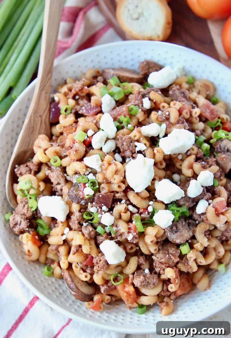 Overhead image of ground lamb pasta topped with feta cheese crumbles