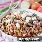 Ground lamb pasta in bowl with spoon