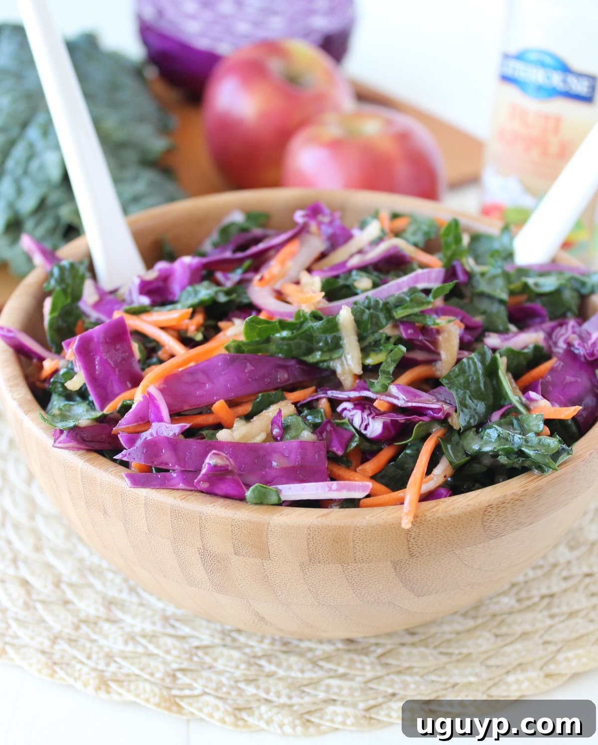 A serving of vibrant Kale Apple Slaw artfully arranged in a small white bowl, garnished and ready for consumption, highlighting its fresh appeal.