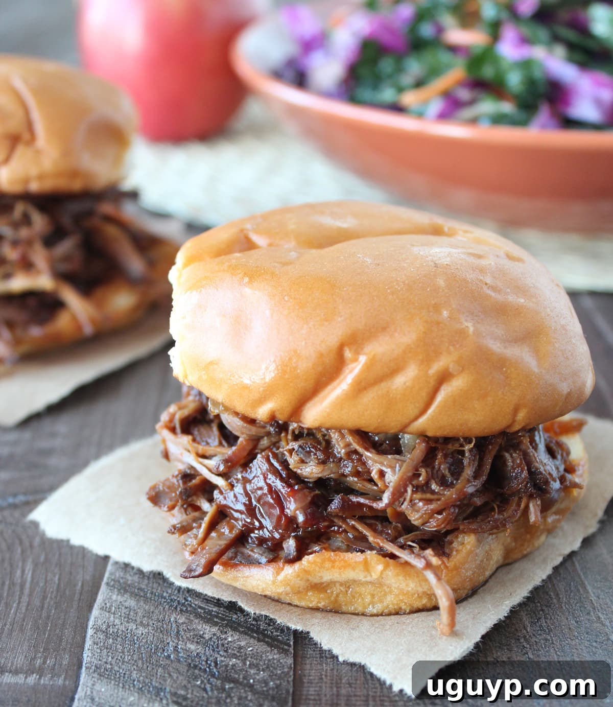 shredded bbq brisket in between toasted hamburger buns