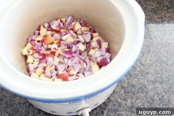 diced onions and apples in a Crock Pot