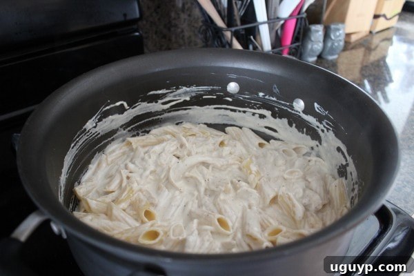 Chicken Caesar Baked Pasta Recipe, mixing pasta and sauce