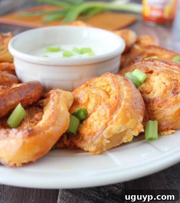 Vegetarian Buffalo Cheesy Puff Pastry Rolls served on a board