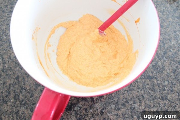 Mixing cream cheese, buffalo sauce, and blue cheese dressing