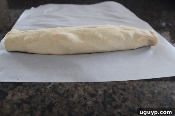 Rolling up the puff pastry dough with filling