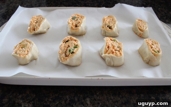 Sliced Buffalo Cheesy Puff Pastry Rolls on baking sheet