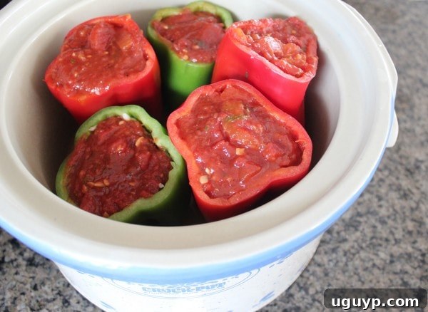 Filled Italian Stuffed Peppers arranged in a slow cooker, ready for cooking