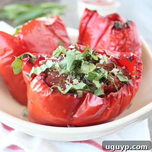 Finished Slow Cooker Italian Stuffed Peppers, topped with fresh basil and parmesan