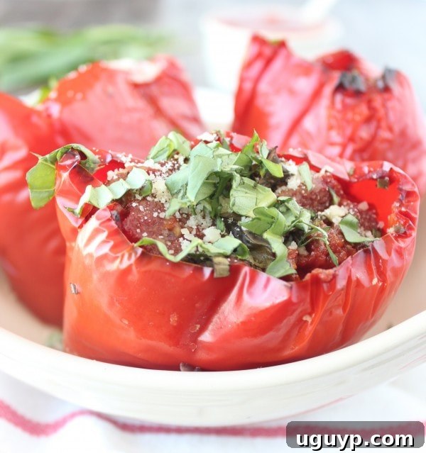 Close-up of three vibrant Slow Cooker Italian Stuffed Peppers, showcasing the rich filling and melted mozzarella