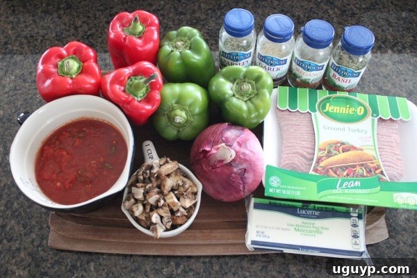 A collection of fresh ingredients for Slow Cooker Italian Stuffed Peppers including bell peppers, ground turkey, mushrooms, and cheese