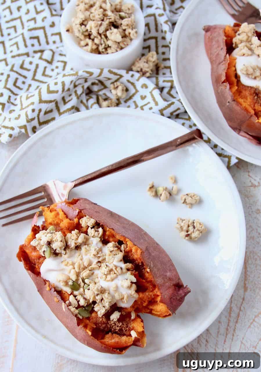 Overhead image of roasted sweet potato filled with yogurt and granola, ready to eat