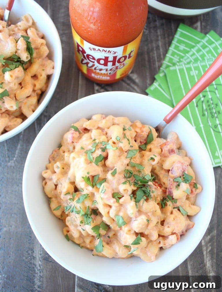 macaroni and cheese in white bowl with orange fork