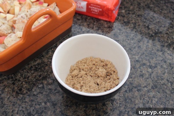 A small bowl containing brown sugar crumble, a mixture of brown sugar, flour, and cold butter, ready to be sprinkled.