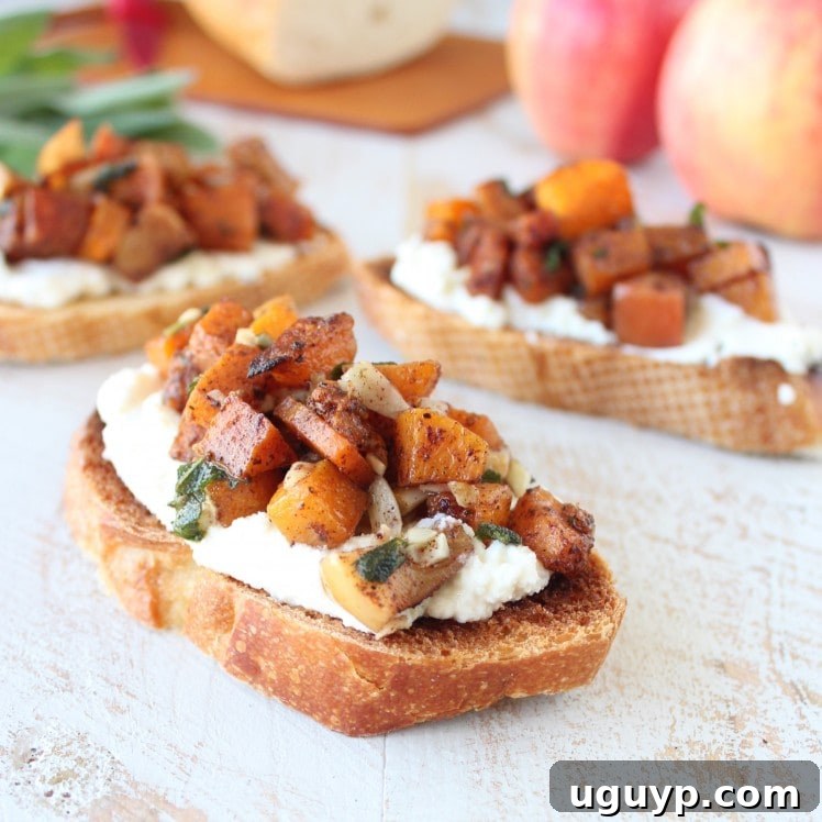 Beautifully assembled bruschetta with diced roasted butternut squash and apples layered over creamy ricotta cheese on golden toasted bread slices, ready to be drizzled with balsamic glaze.