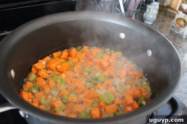 Adding broth and seasoning to sweet potato stuffing mixture
