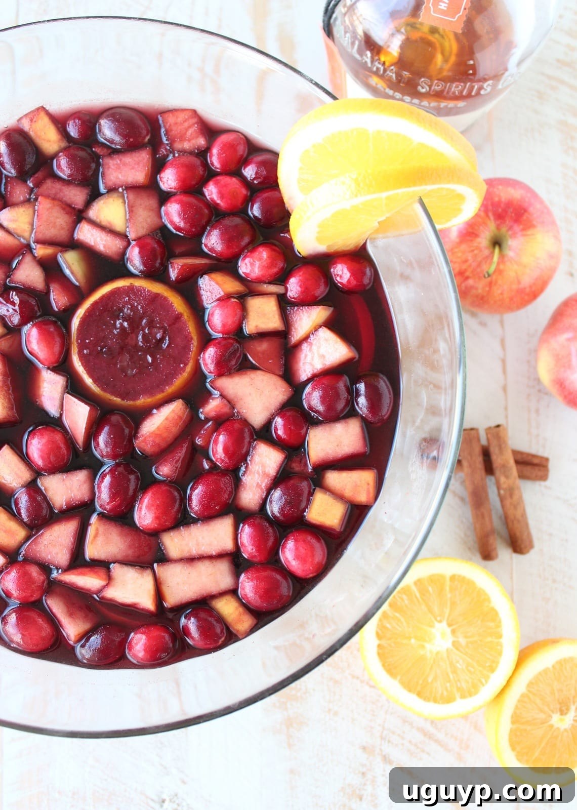 A large pitcher of Cranberry Apple Sangria chilling in the refrigerator