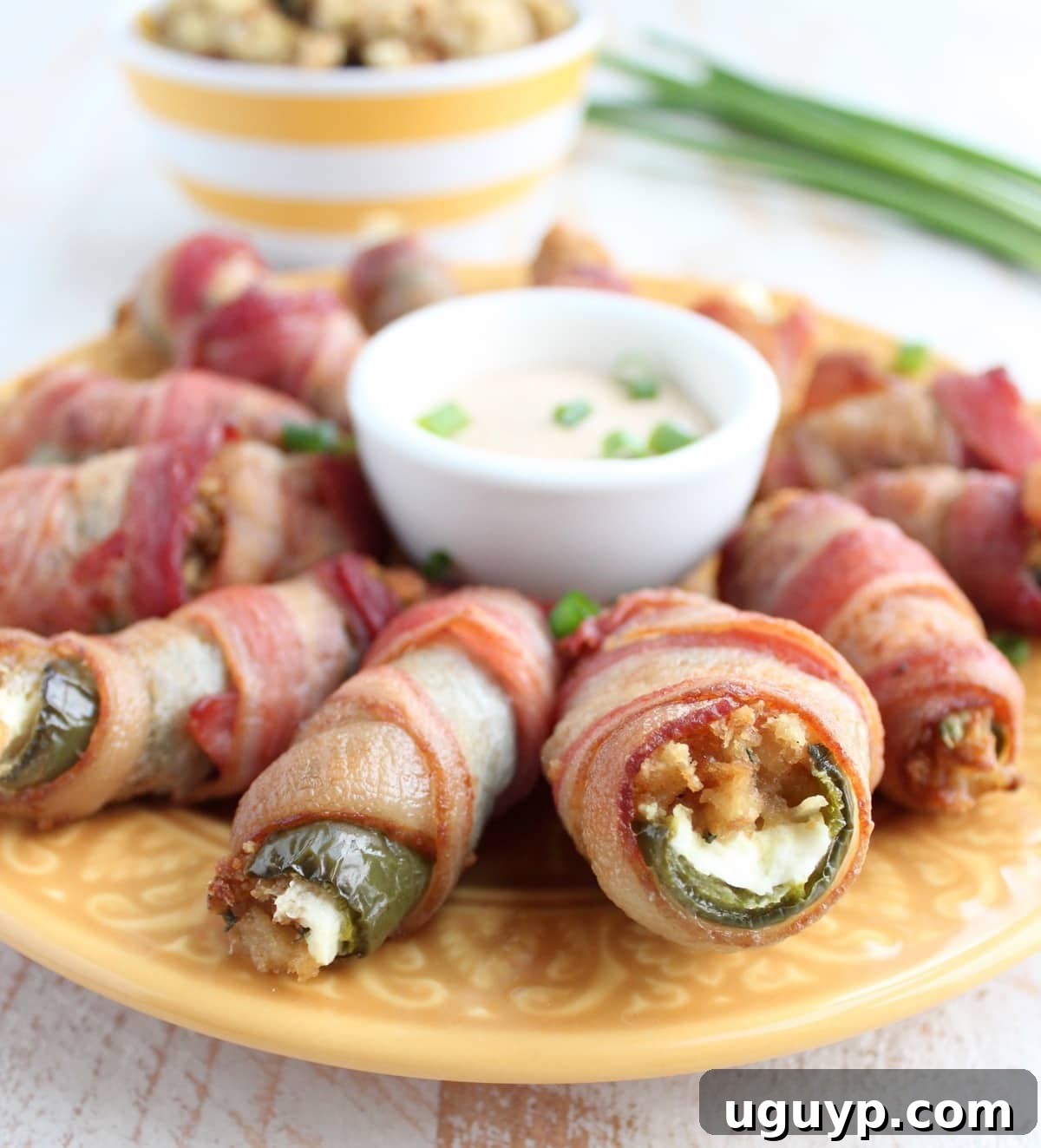Crispy Bacon Wrapped Stuffing Cream Cheese Jalapeno Poppers on a platter, ready to serve