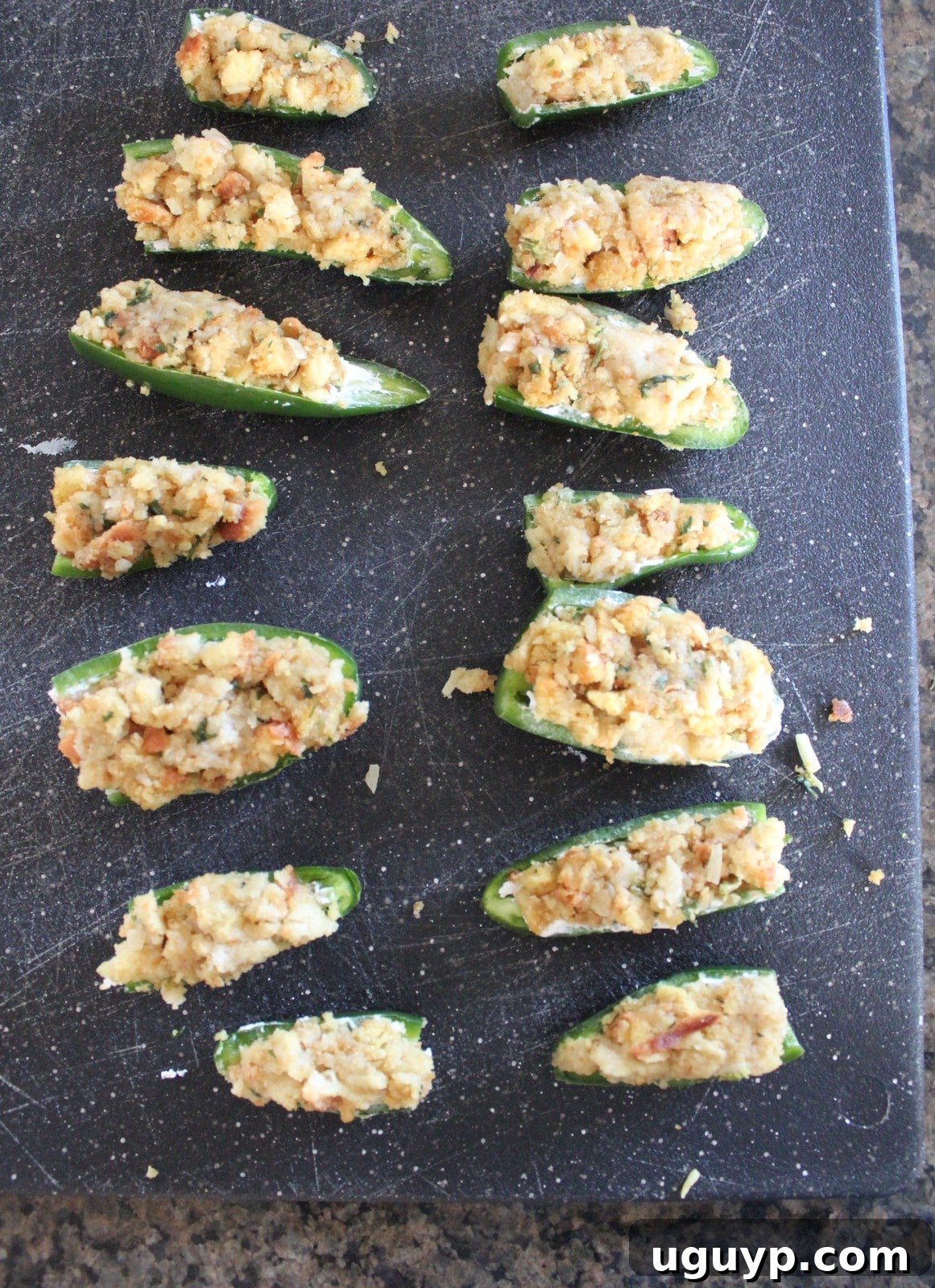 Jalapeno halves filled with cream cheese and topped with stuffing