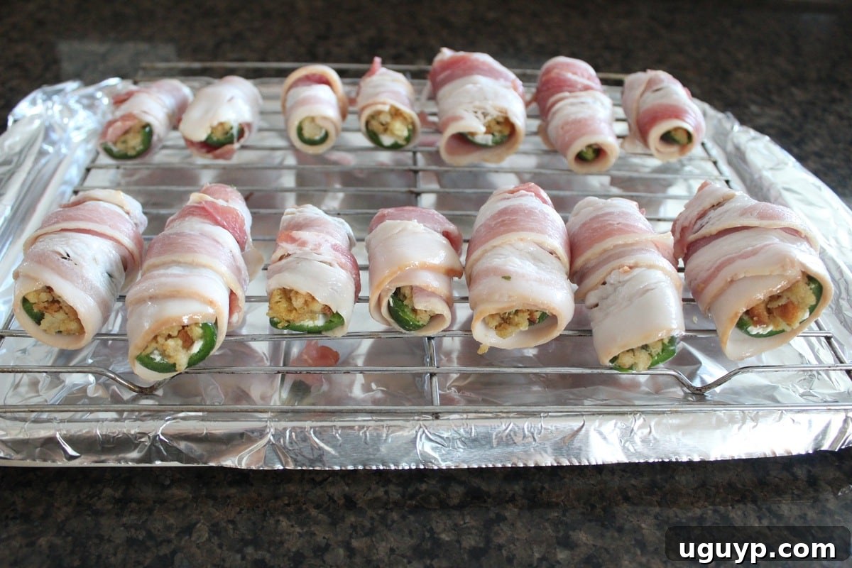 Jalapeno poppers wrapped with bacon, ready for baking