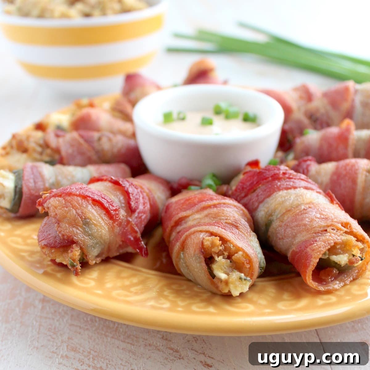 Bacon Wrapped Stuffing Cream Cheese Jalapeno Poppers baking on a wire rack