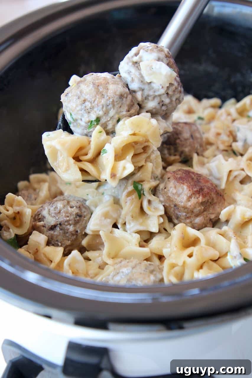 Slow Cooker Swedish Meatballs being served from the crockpot