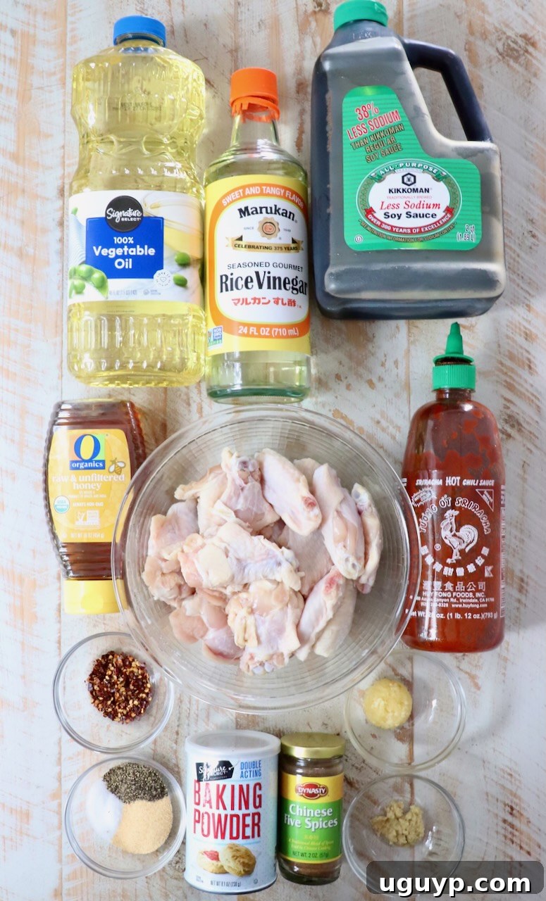 Ingredients for homemade General Tso chicken wings laid out on a white wooden board