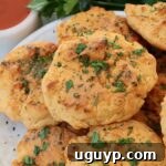 cheddar biscuits stacked up on a plate
