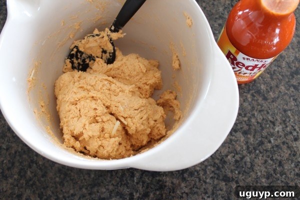 biscuit dough with buffalo sauce and cheddar cheese