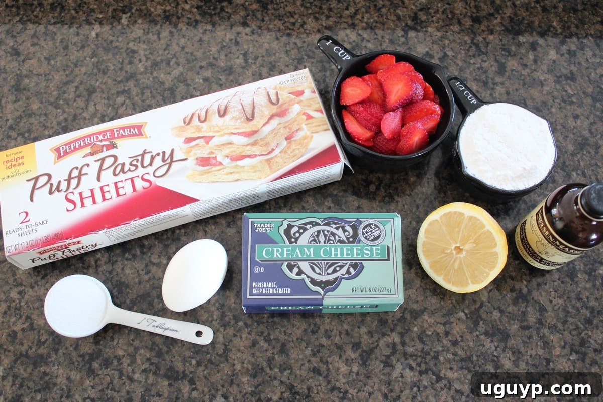 Ingredients for Heart Shaped Strawberry Cheesecake Puff Pastry Pies, including cream cheese, strawberries, sugar, and puff pastry