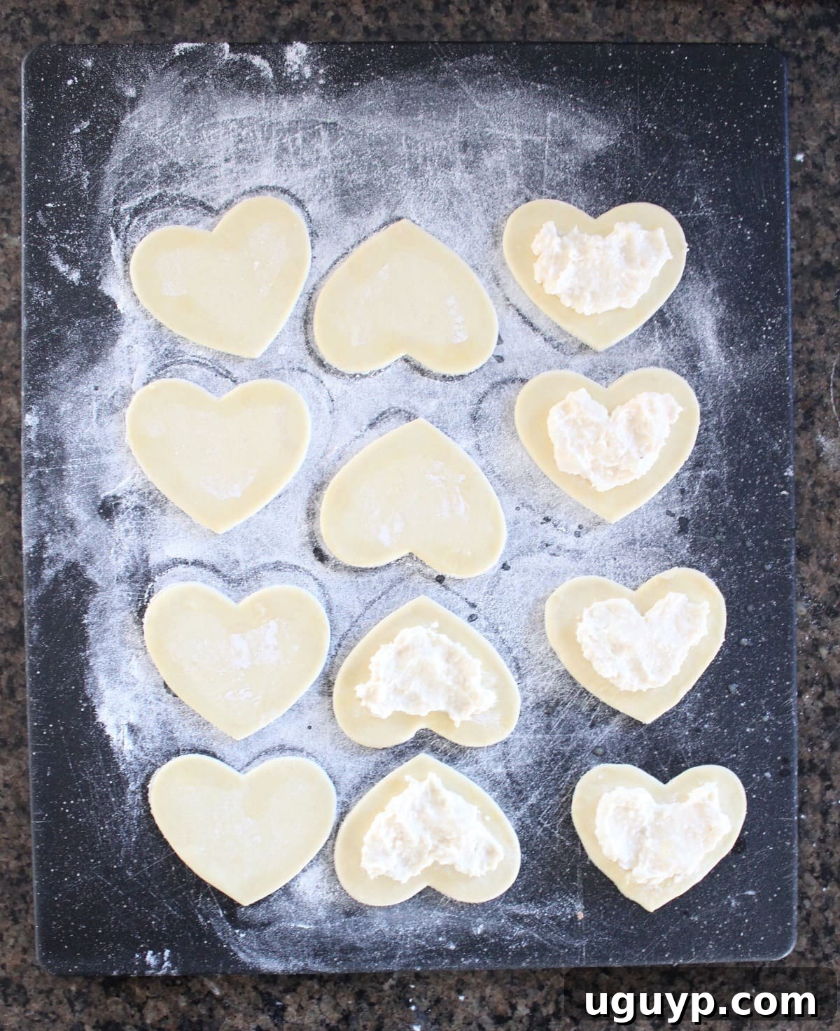 Filling heart-shaped puff pastry with cream cheese mixture