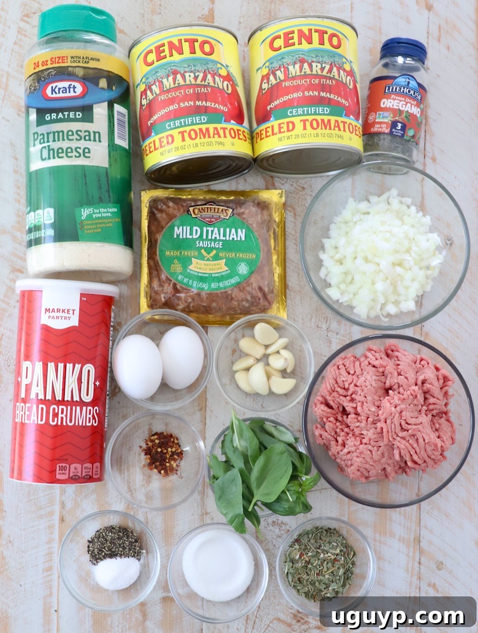 ingredients for slow cooker meatballs and marinara sauce on white wood board