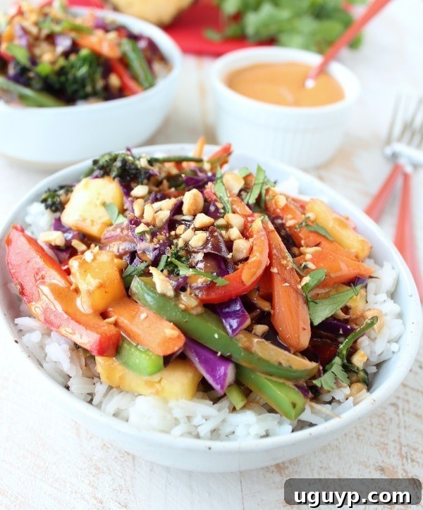 Freshly cooked Thai Peanut Pineapple Veggie Rice Bowl with chopsticks