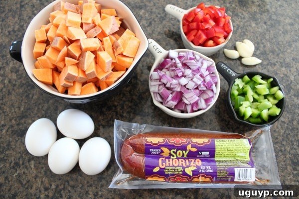 A selection of fresh ingredients for Mexican Sweet Potato Hash: sweet potatoes, bell peppers, onion, garlic, and soyrizo.