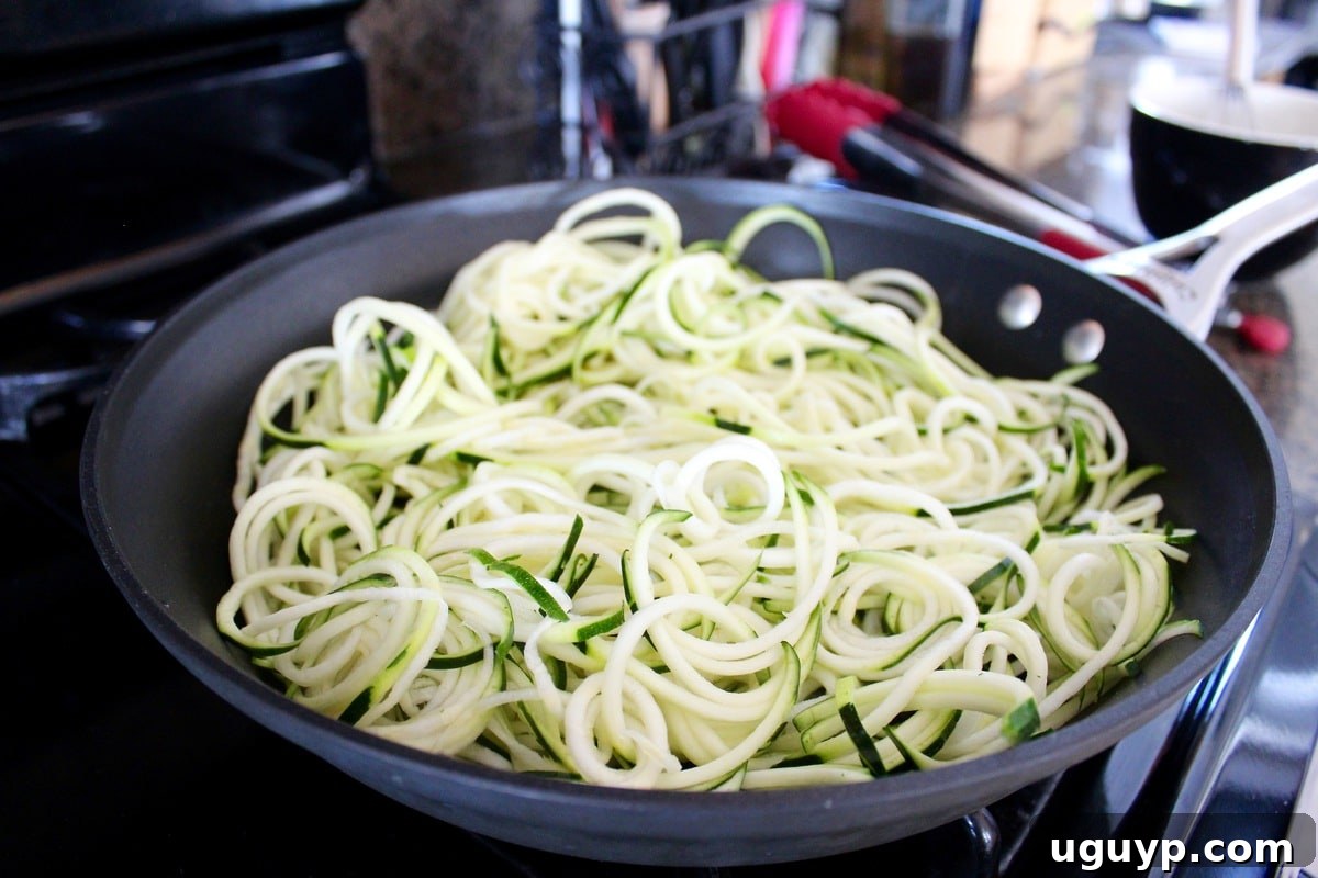 zucchini noodles in a large skillet
